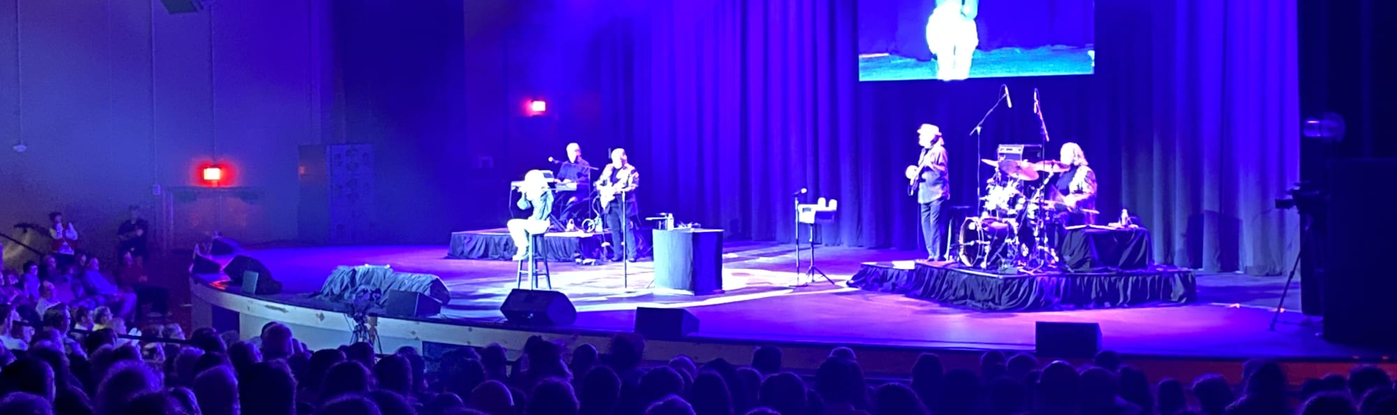 signer on stage in chair washed out by the lights Dayton