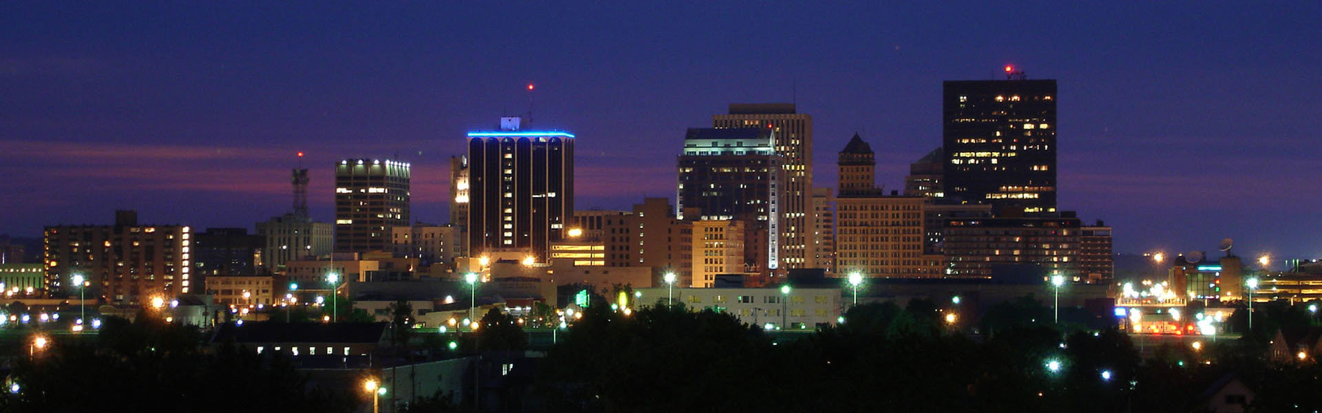 Neon color image of a band playing and people singing along