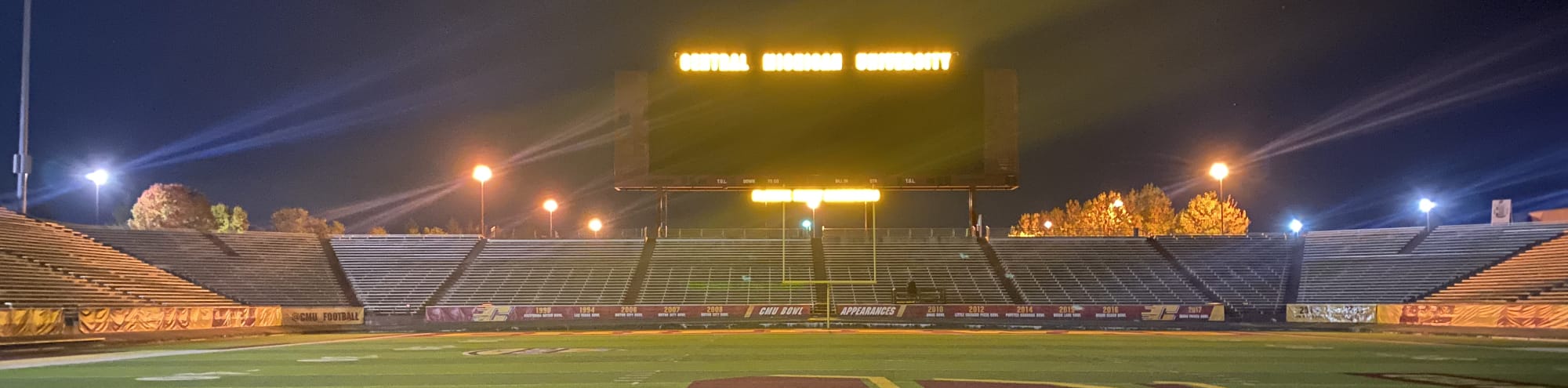 empty football stadium at night under the lights Dayton